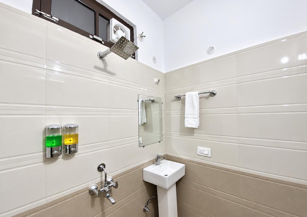Bathroom at Tapovan New Residency with rain shower, fresh towels and toiletries